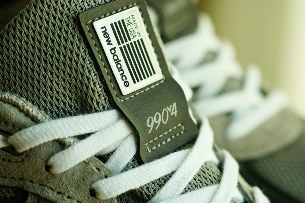 Detailed close-up of New Balance 990v4 sneaker showcasing label and design.